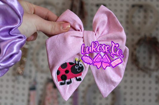 Glittery pink ladybug hand-tied (this is cotton fabric)